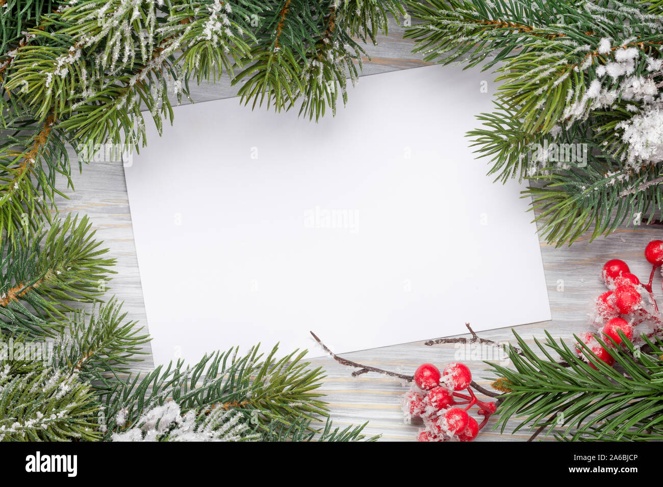 Christmas greeting card and fir tree branch over wooden texture ...