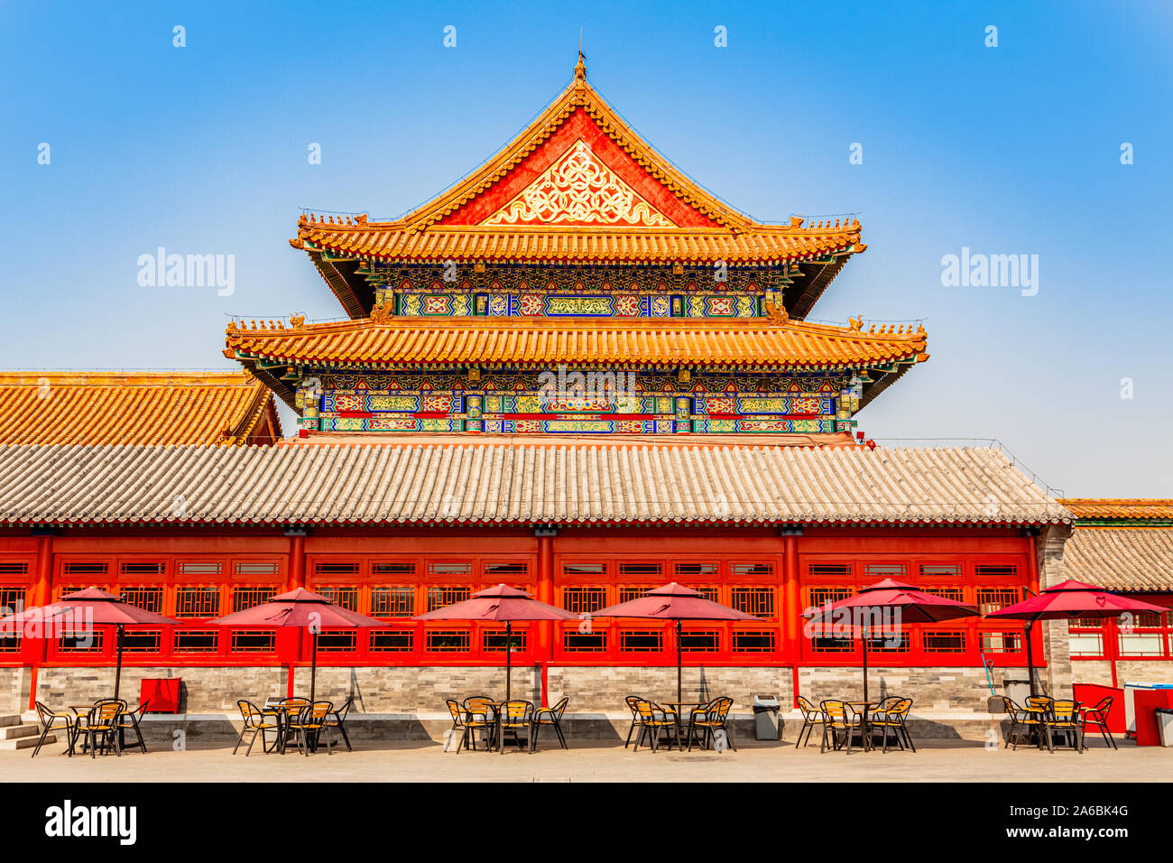 Summer cafe with tables and umbrellas at the wall of one of the royal emperor palace in Forbidden city, Beijing, China Stock Photo