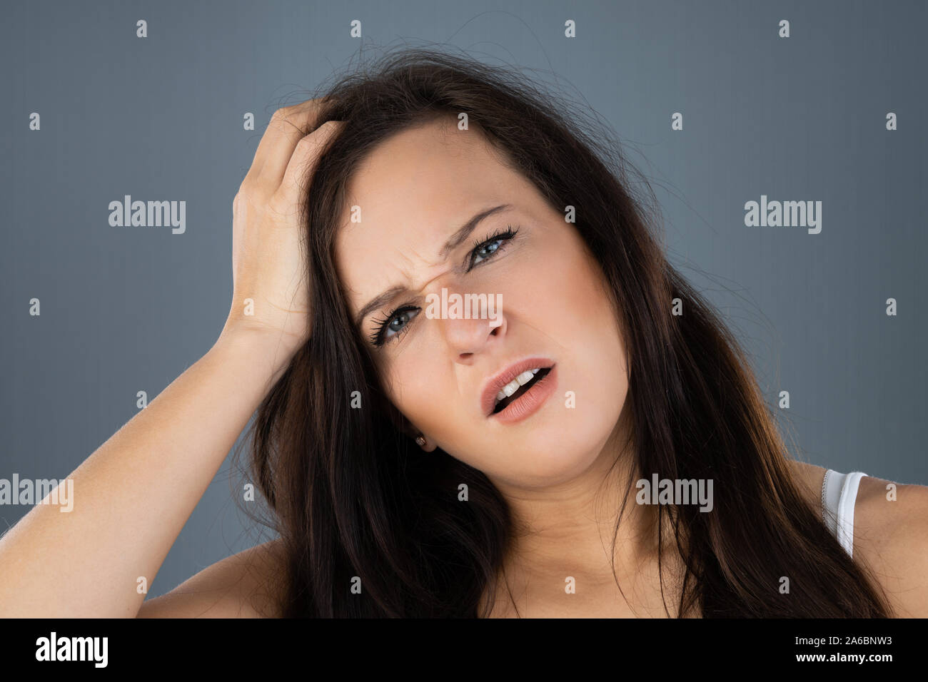 Young Woman Scratching Her Itchy Head Scalp Stock Photo
