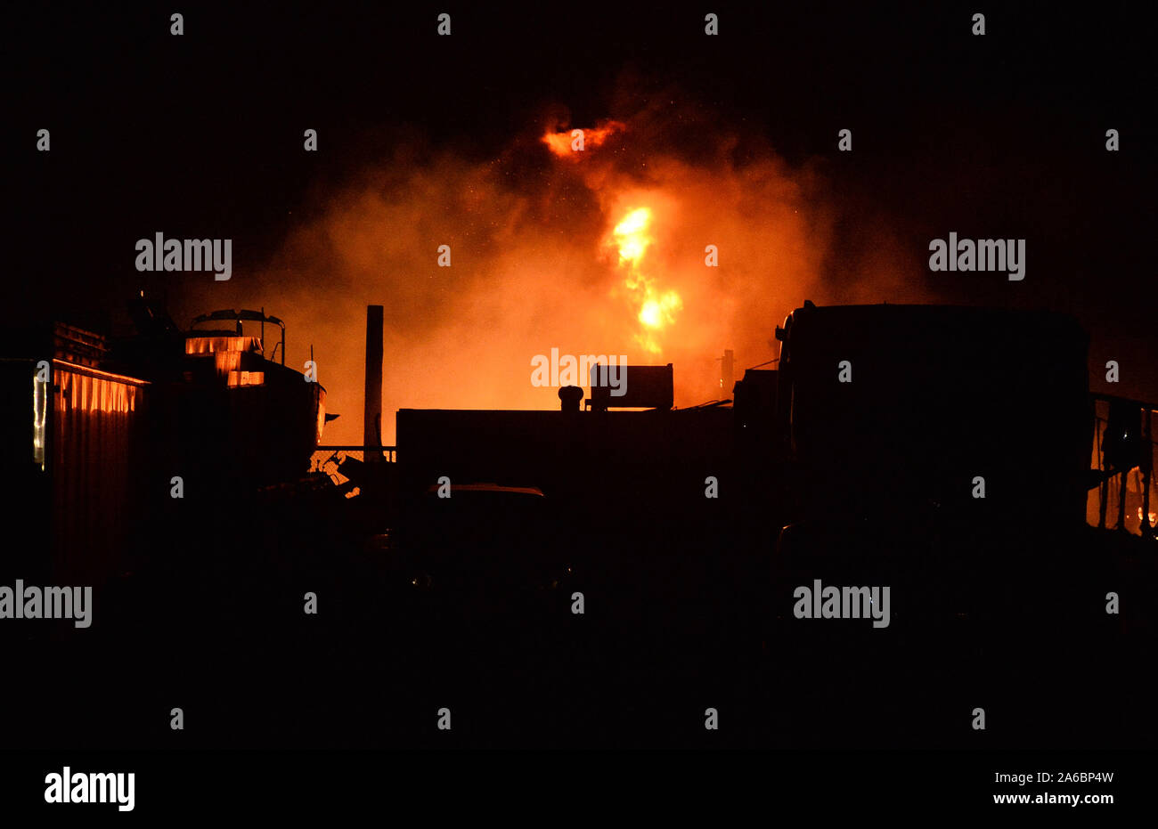 Santa Clarita, USA. 25th Oct, 2019. Flames fanned by Santa Ana winds burn cars and tractor trailers in a storage lot off Sierra Highway in the Santa Clarita Valley where multiple homes burned in the Tick Fire on Friday, October 25, 2109. Credit: UPI/Alamy Live News Stock Photo