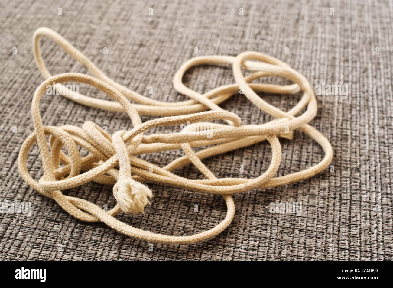 Tangled string on gray fabric Stock Photo Alamy
