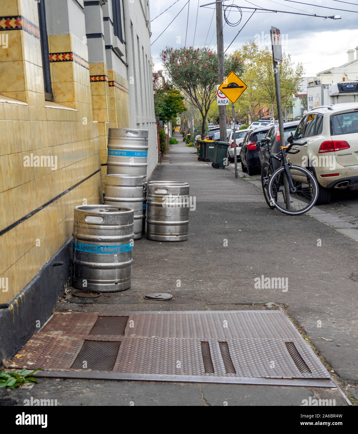 Metal beer kegs on the footpath outside a suburban hotel pub in Fitzroy Melbourne Victoria Australia. Stock Photo