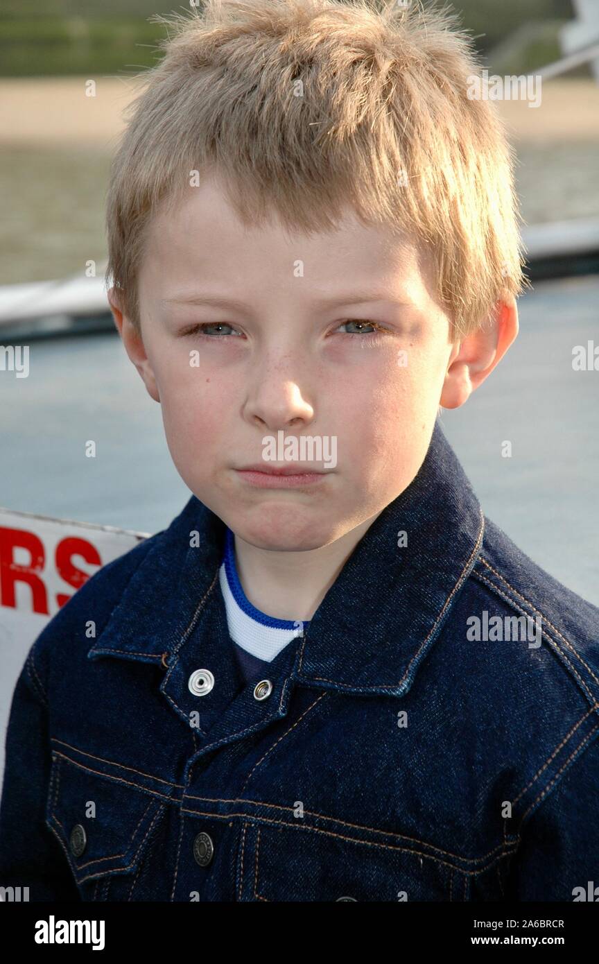 Eight year old boy with a serious expression. Stock Photo