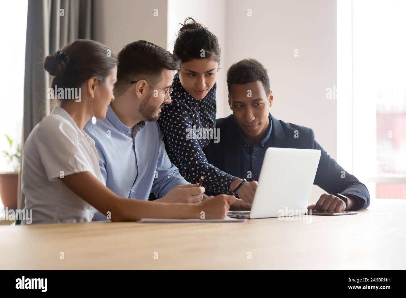 Multiracial successful team working together on project in office Stock Photo