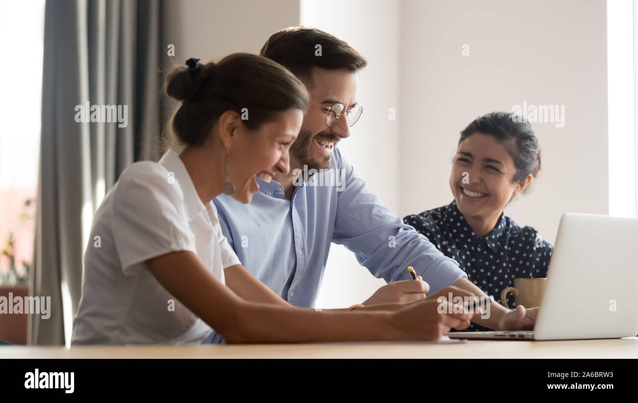 Multiracial laughing positive team having fun in office Stock Photo