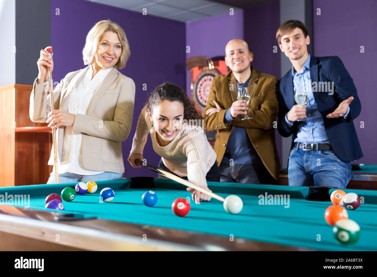 Billiards game. young friends playing pool together Stock Photo - Alamy