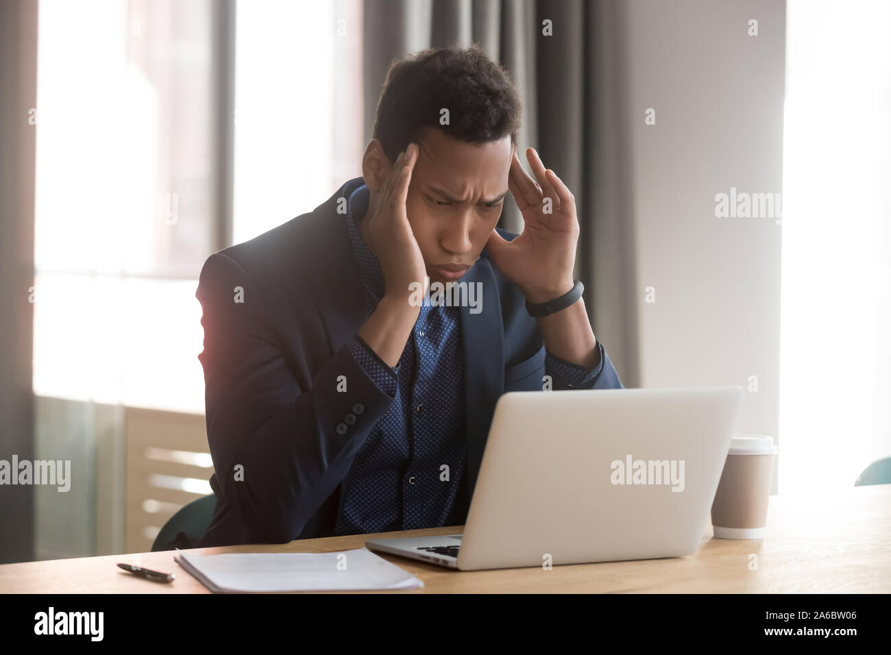 Stressed depressed african american manager feels headache at office Stock Photo