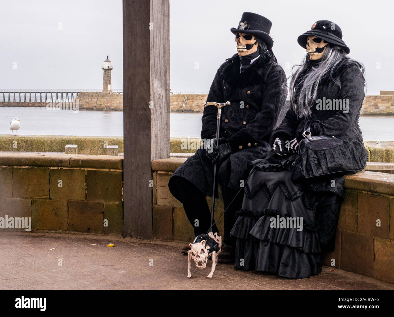 Couple in traditional Goth costumes with skeleton dog, Whitby Goth Weekend Festival, Whitby, North Yorkshire, UK, 25 October 2019 Stock Photo