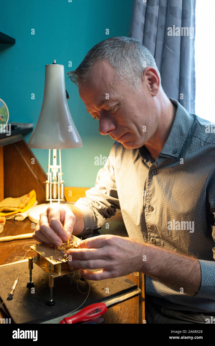 A specialist watch repair fixes a carriage clock Stock Photo Alamy