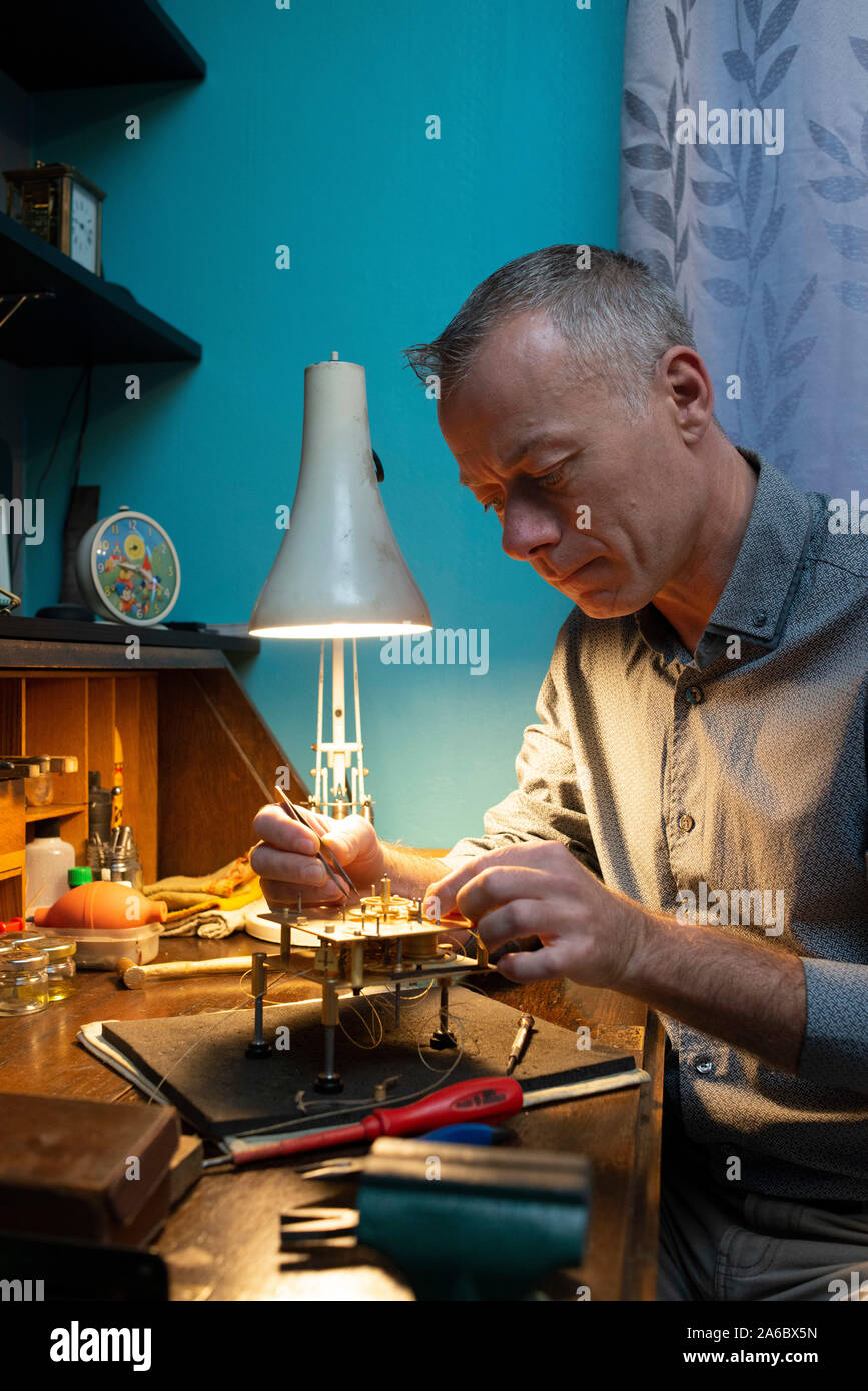 A specialist watch repair fixes a carriage clock Stock Photo Alamy