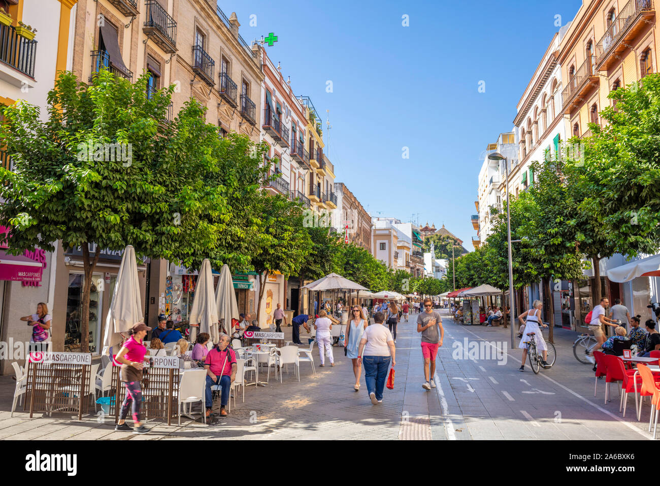 Street pavement cafe on the Calle San Jacinto Main street in the Triana district of Seville Sevilla Seville Spain seville Andalusia Spain EU Europe Stock Photo