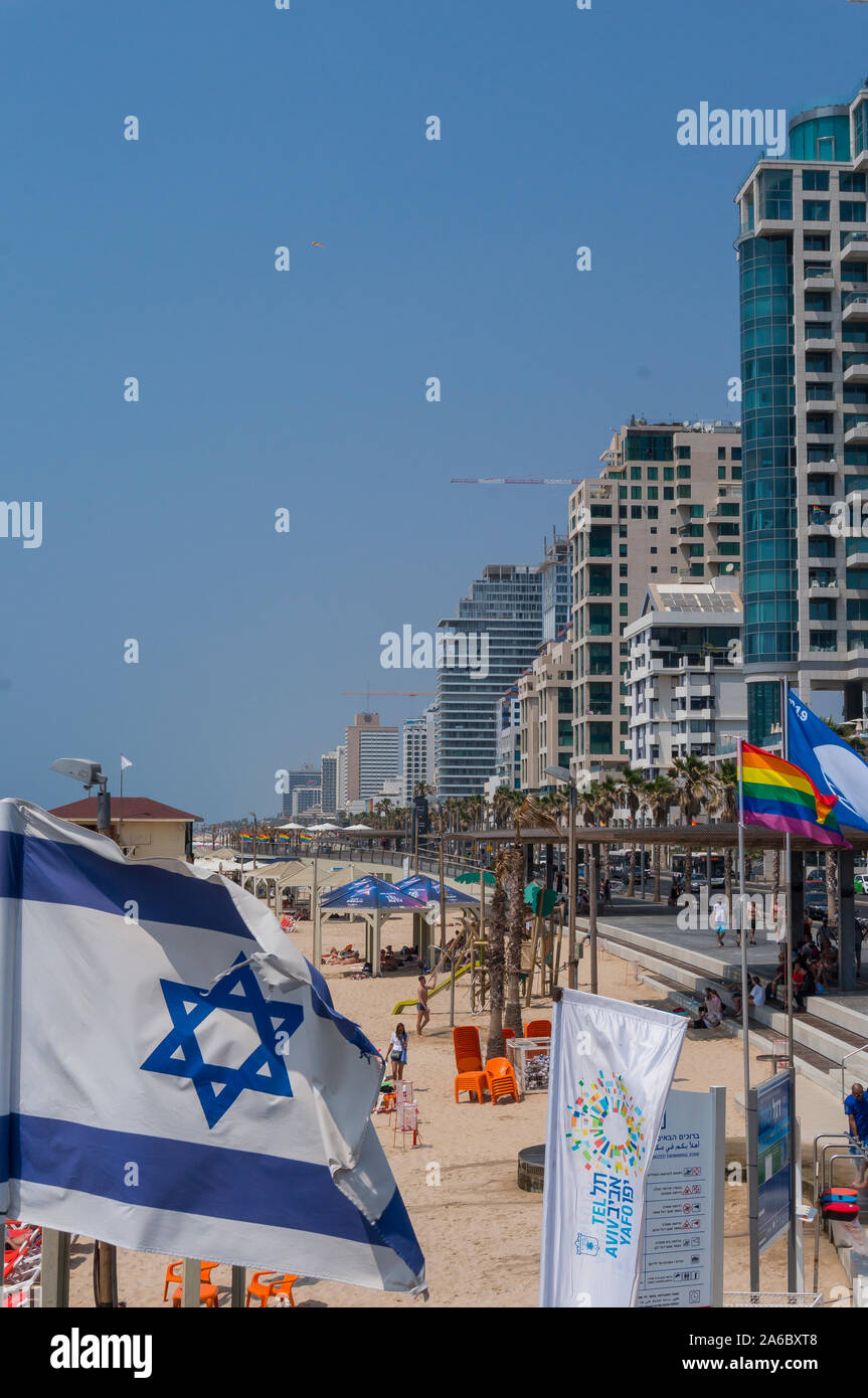 Israeli national flags fluttering on a wind. The flag of Israel with modern Tel  Aviv in background. Tel Aviv beach Stock Photo - Alamy