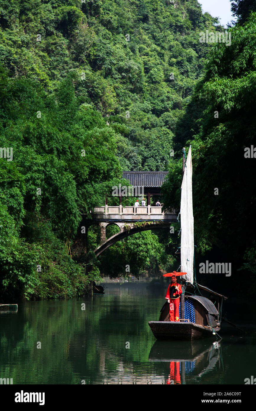 Chinese woman in traditional dress on boat at Tribe of The Three