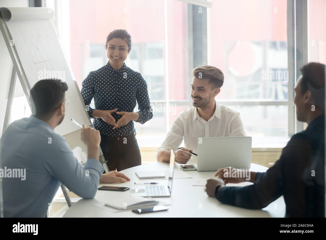 Young happy multiracial team positive working process Stock Photo