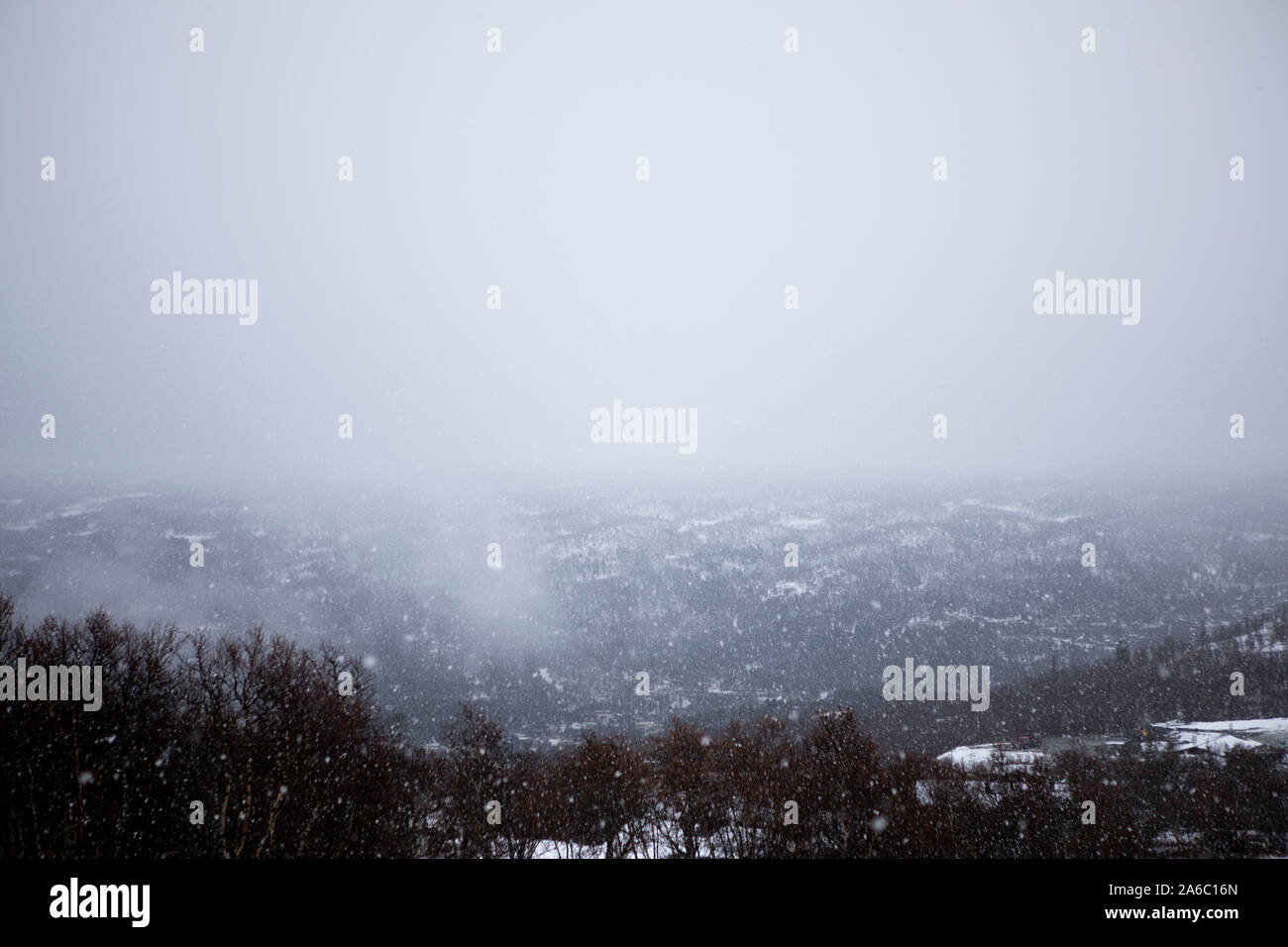 foggy snow fall in the mountains Stock Photo