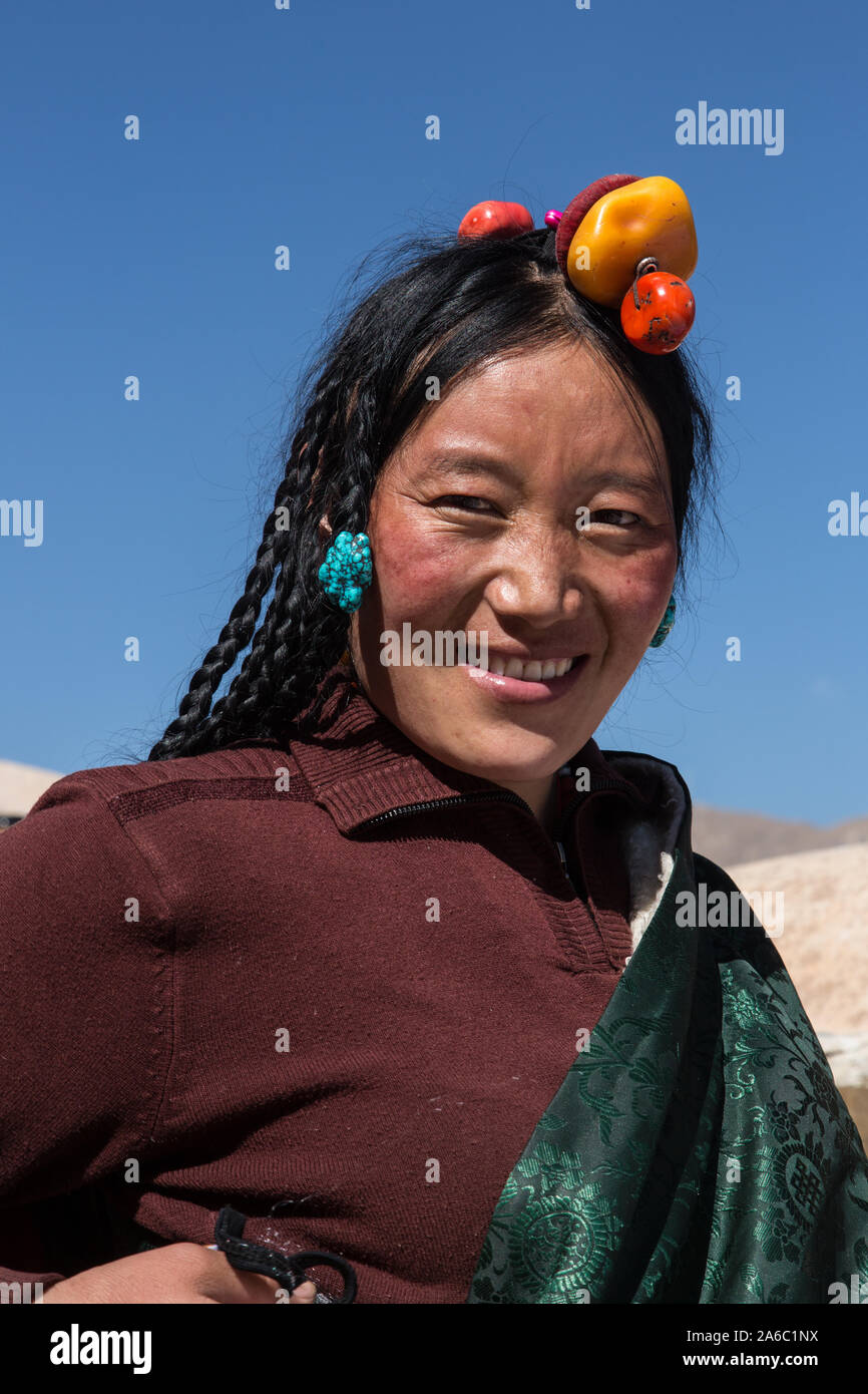 A Khamba Tibetan woman from the Kham region of eastern Tibet with her hair in traditional style