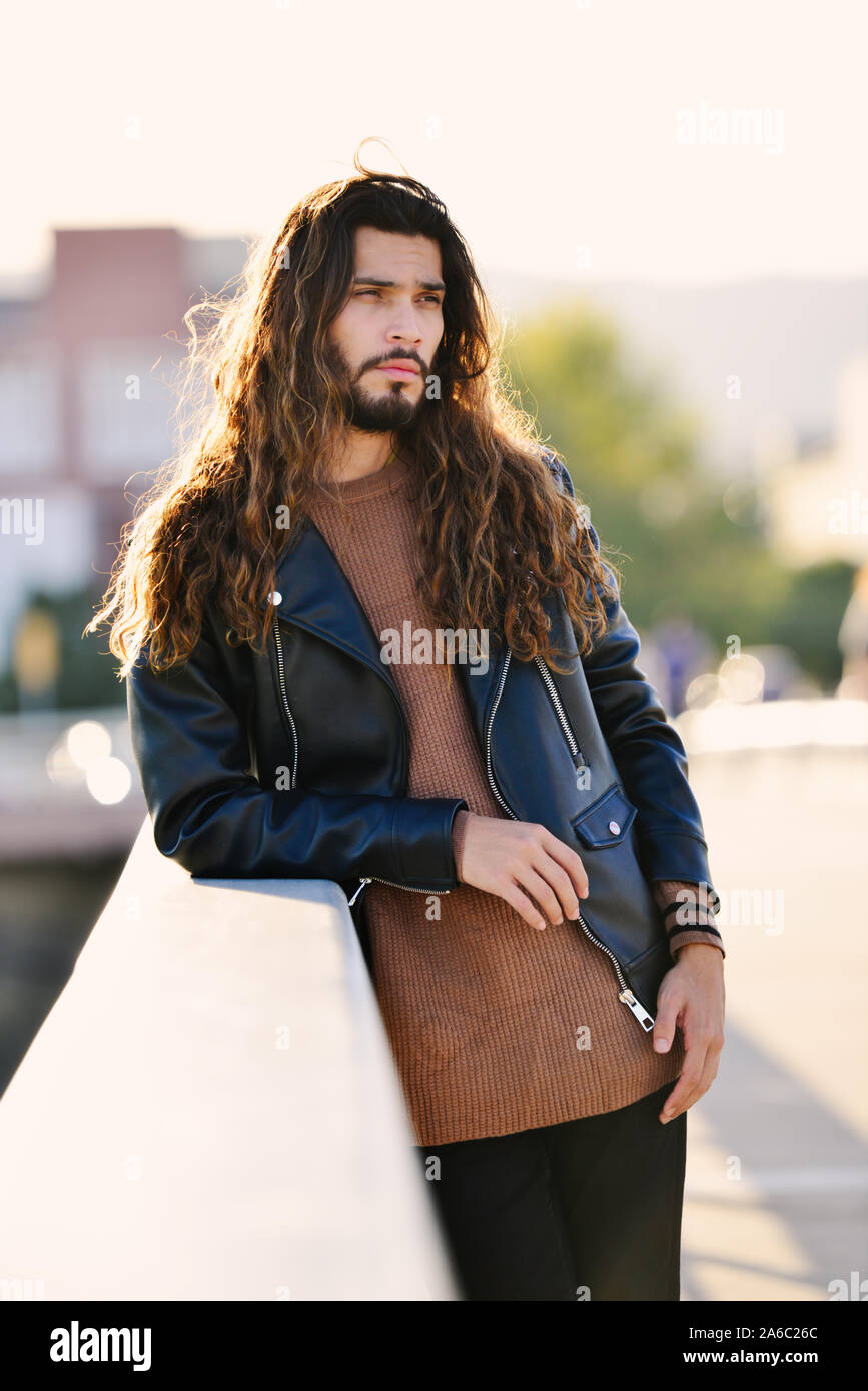 Handsome young Colombian man with long hair Stock Photo - Alamy