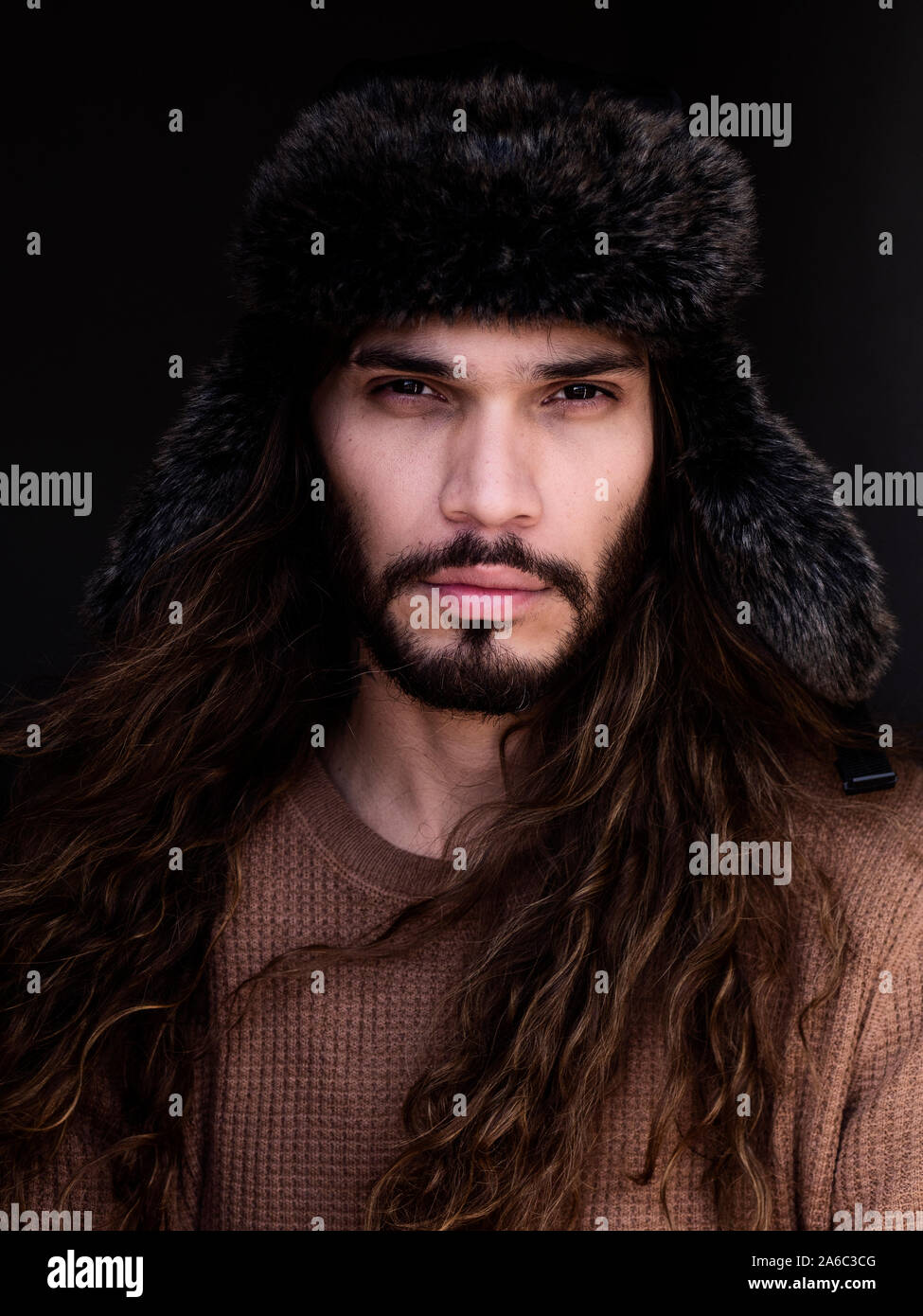 Handsome young Colombian man wearing fur hat Stock Photo