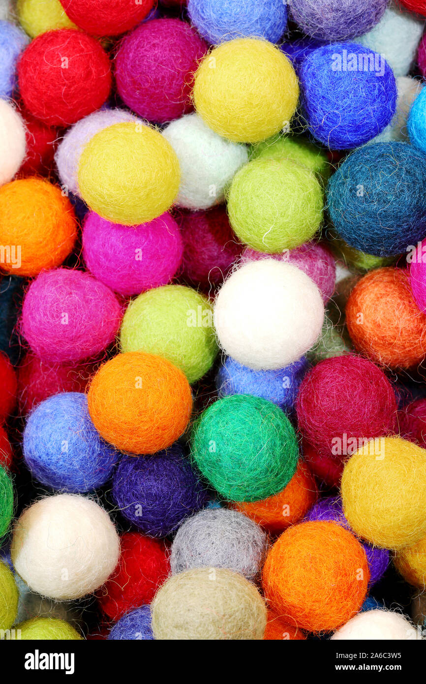background of felt balls for sale as christmas ornaments Stock Photo