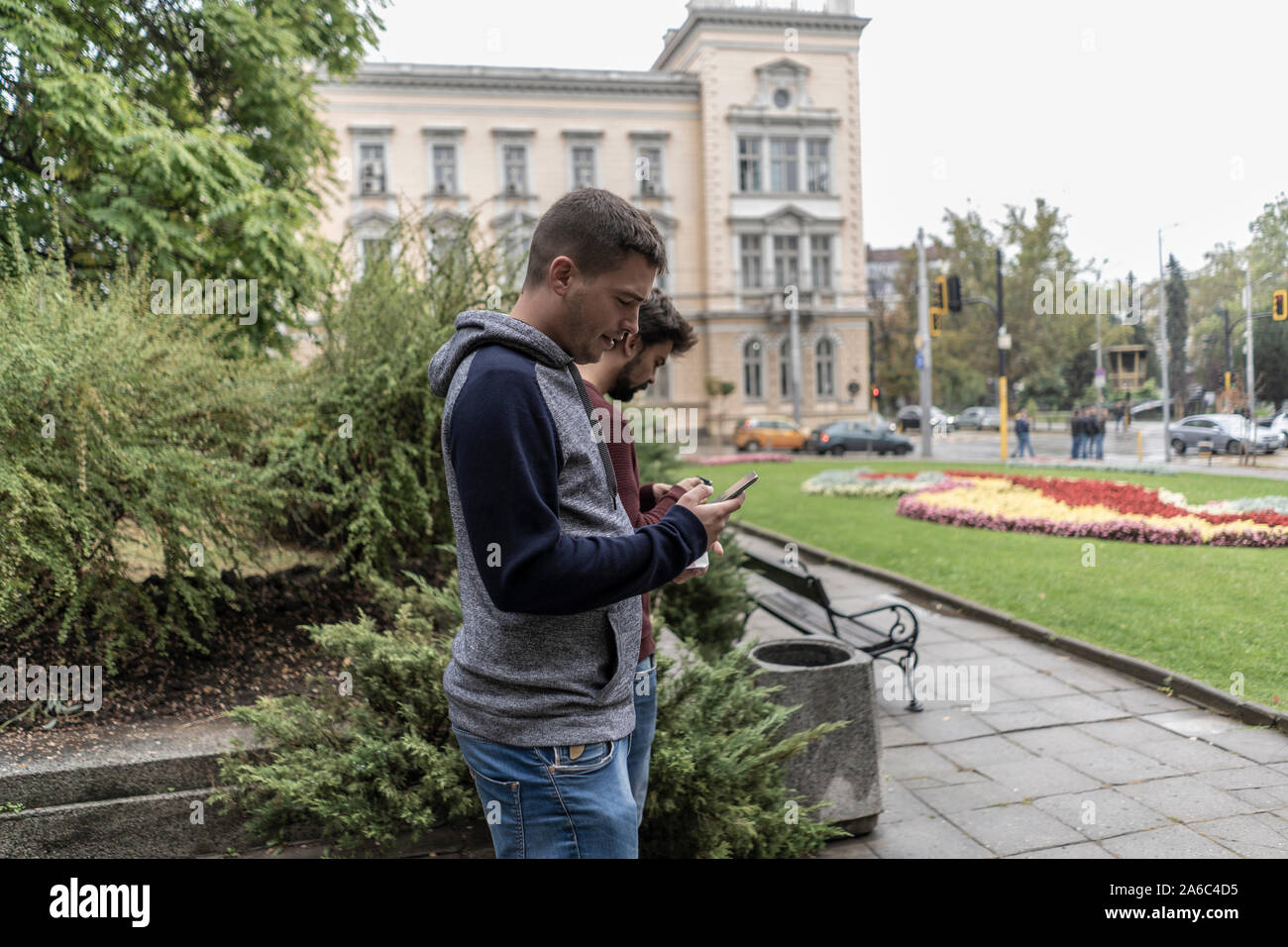 Young man using his mobile in the street Stock Photo