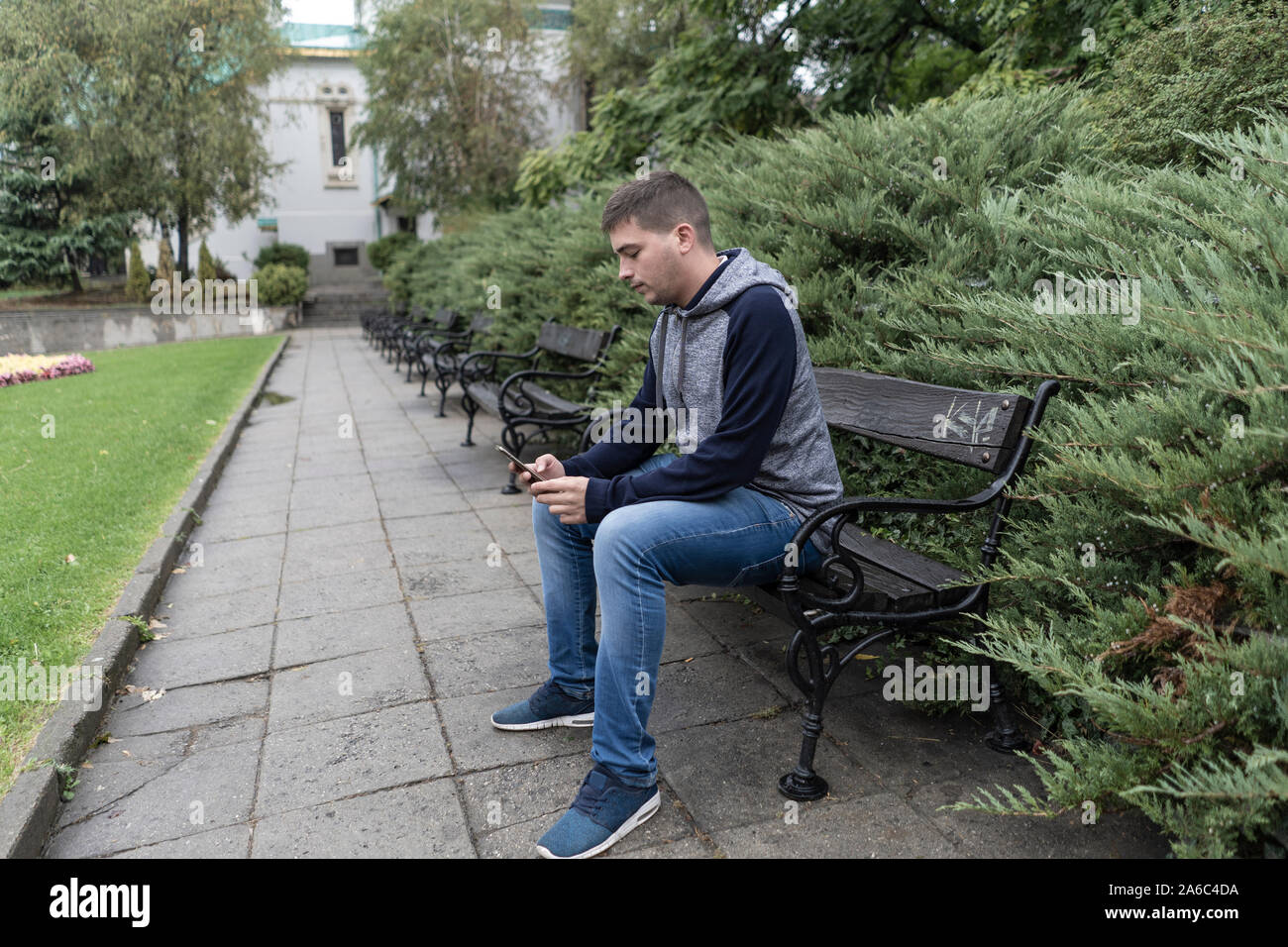 Young man using his mobile in the street Stock Photo