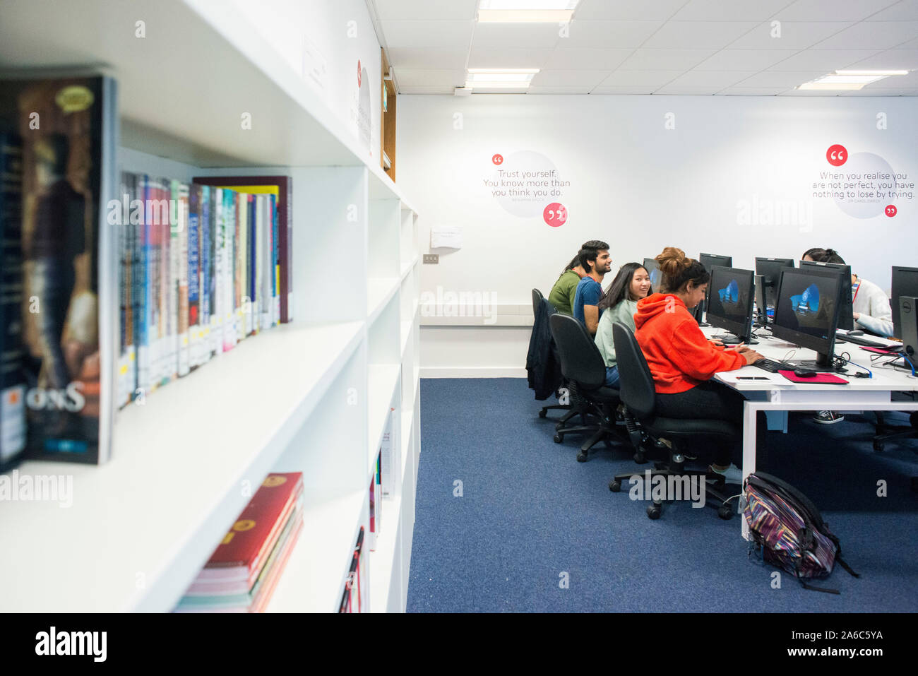 International students reading and working in the college library Stock Photo