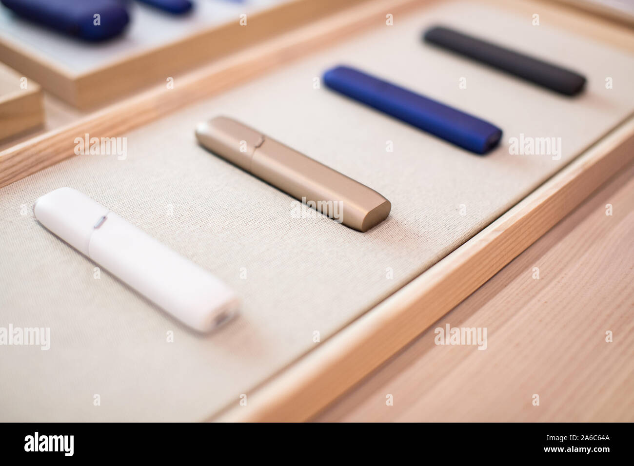 Case for an electronic cigarette on a beautiful shelf for sale. New technologies in tobacco products. Close up. Stock Photo