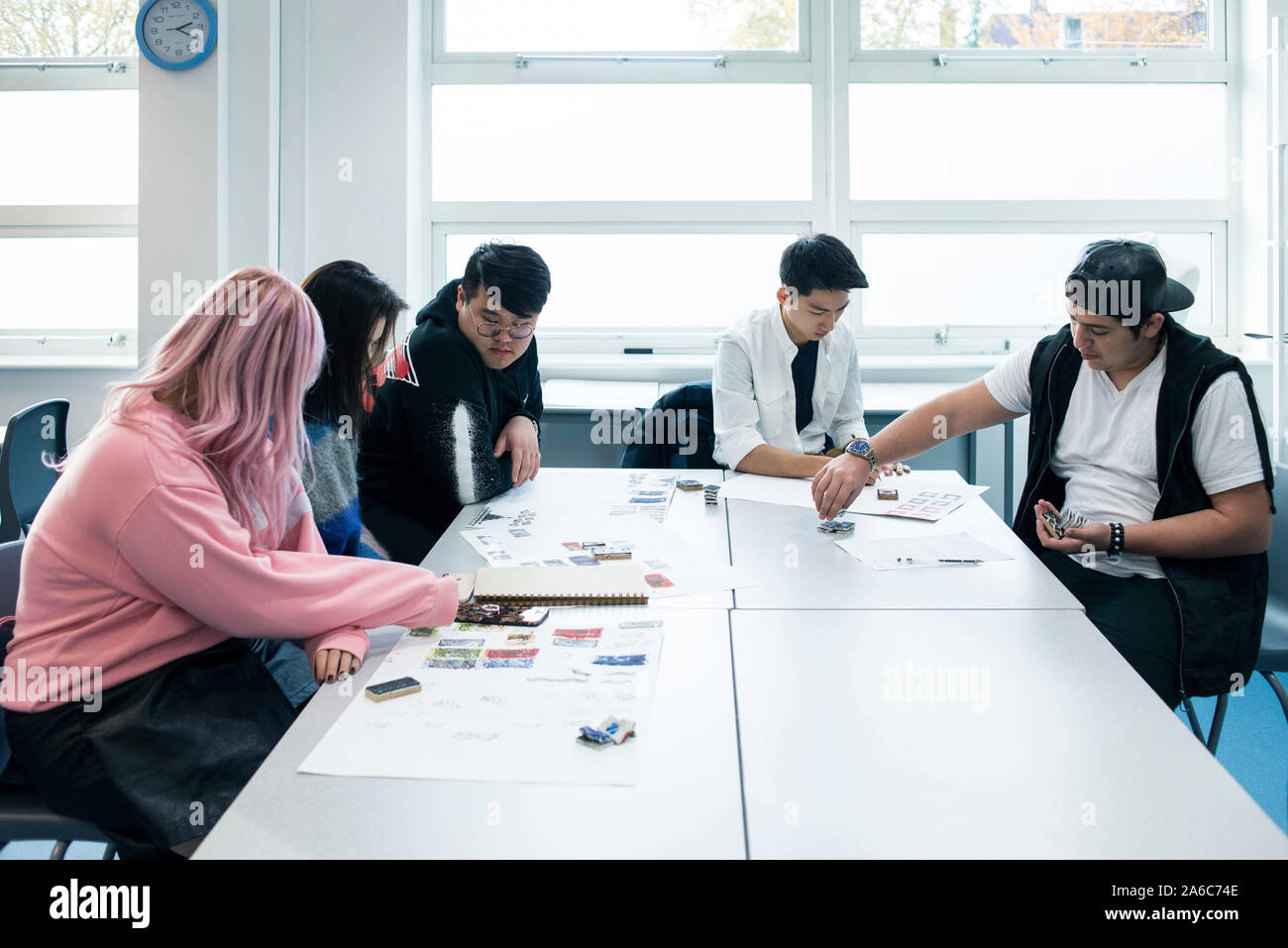 International students in art class study at a table Stock Photo