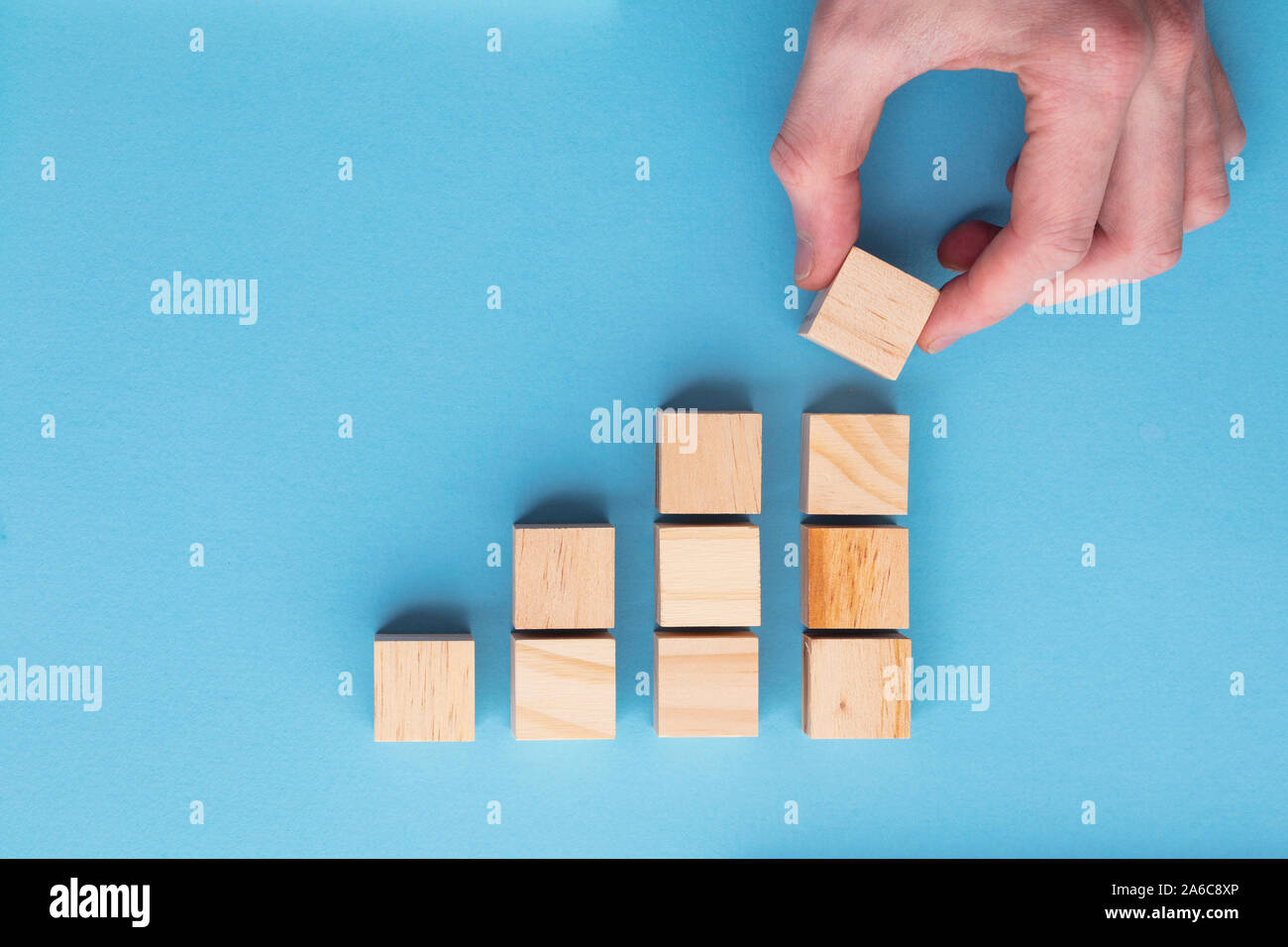 Hand choosing a wooden block from a set. Business choice concept Stock Photo