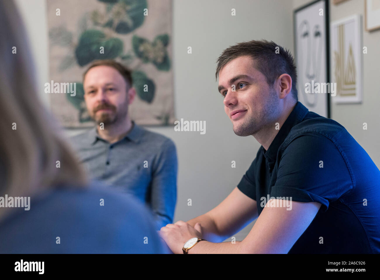 A relaxed and informal creative meeting at a table with laptops. Stock Photo