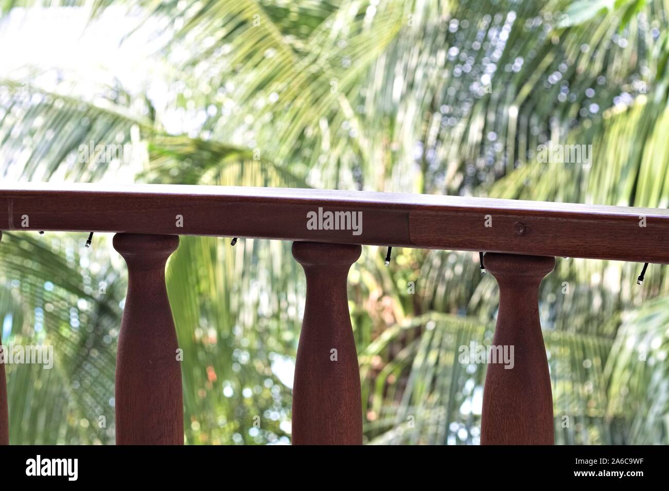 Wooden Railing Of The Balcony With Christmas Lights In A Tropical