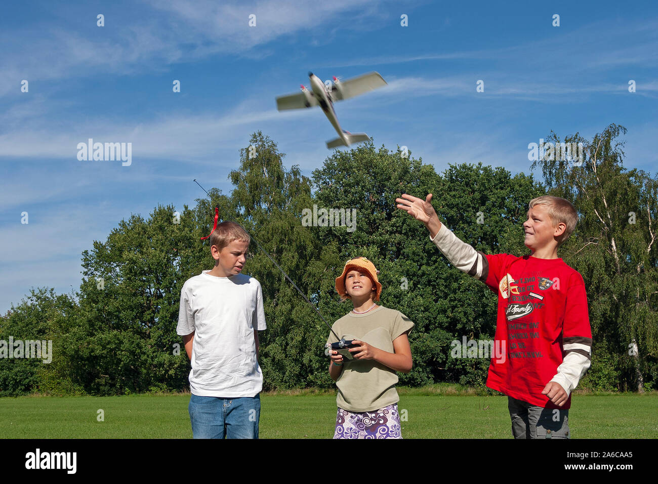 Children are flying a model plane. Stock Photo