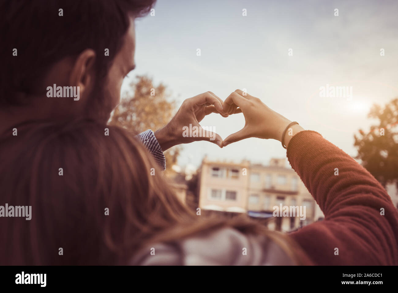 Happy romantic couple in love making  heart shape with hands Stock Photo