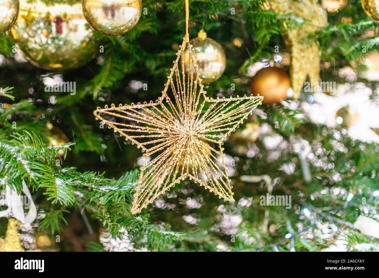 Christmas decorations golden star and snow on pine tree Stock Photo - Alamy