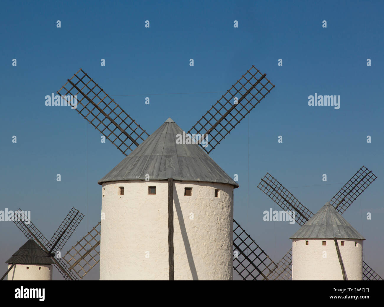 Three windmills against a blue sky in Campo de Criptana, Spain Stock Photo