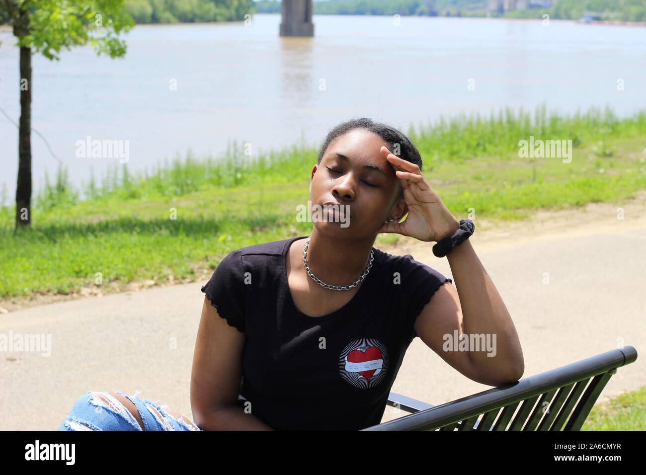 African girl sitting on bench hi-res stock photography and images - Alamy