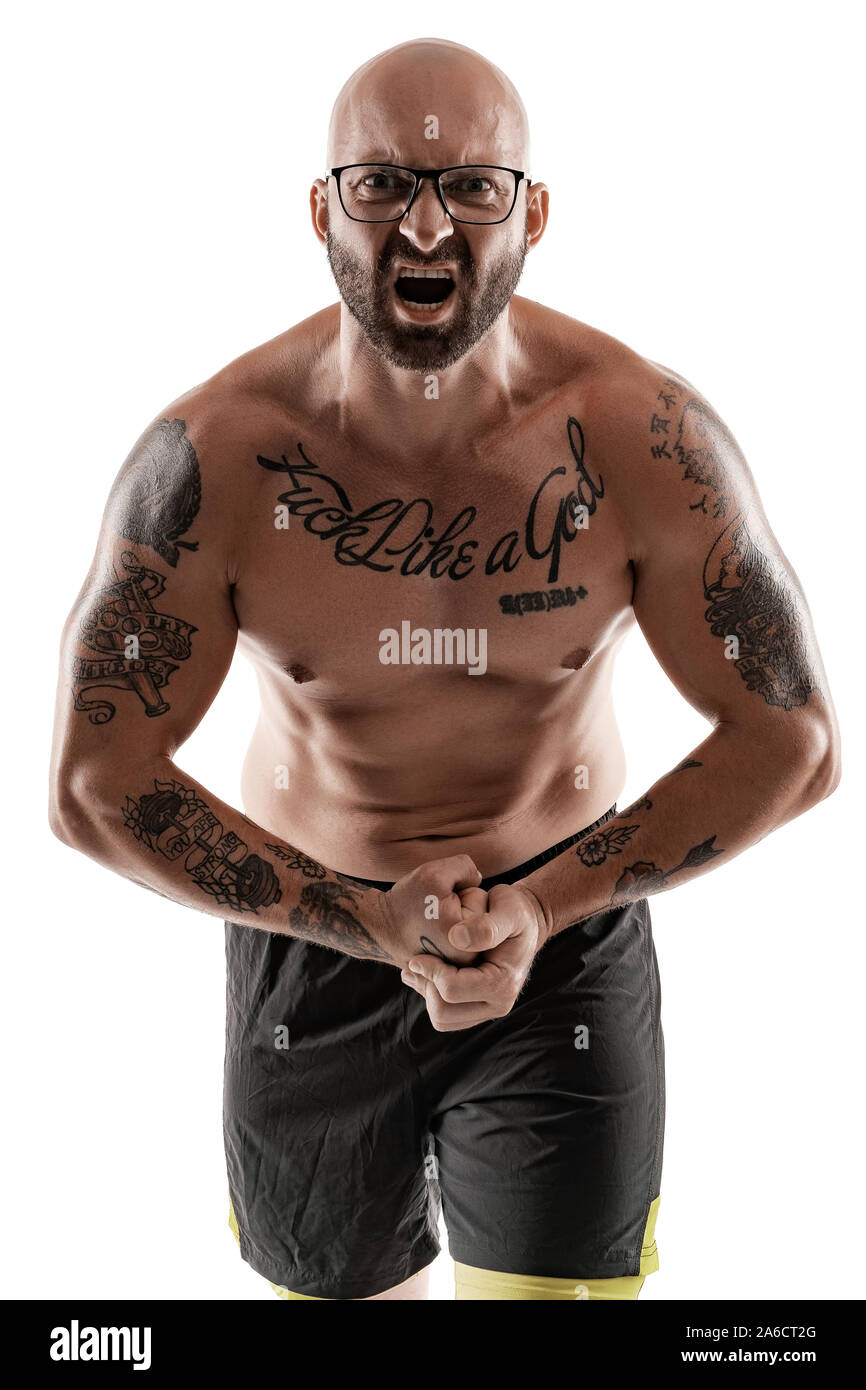 Handsome bald, bearded, tattooed man in glasses, black shorts is posing and  showing his muscles isolated on white background, screaming and looking at  Stock Photo - Alamy