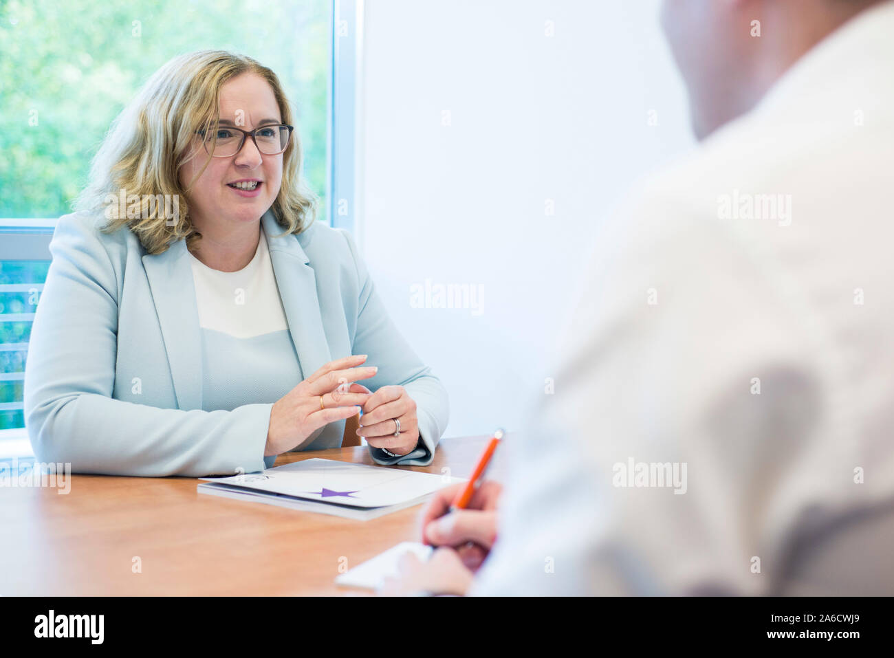 two people sat at a table having a meeting or a job interview Stock Photo