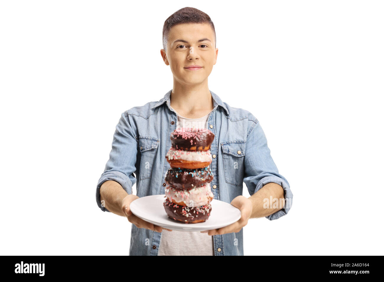 Teenage boy holding a plate of donuts isolated on white background Stock Photo
