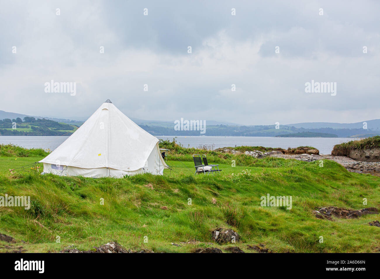 Bell tent and an empty chair at the Eagle Point Camping site near Bantry, West Cork, Ireland. Stock Photo