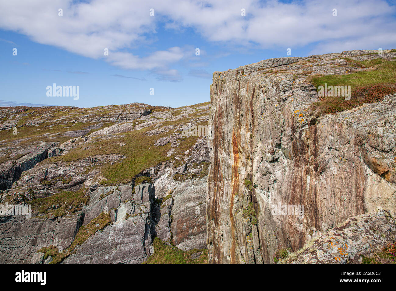 Dramatic cliffs at the Thee Castle Heads in Dunlough, West of Ireland. Blue sky with clouds. Summer. Stock Photo