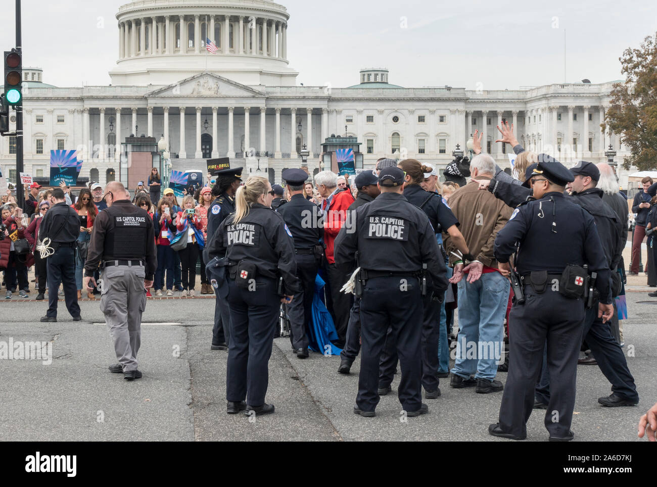 Washington, DC - Oct. 25, 2019: Actress and activist Jane Fonda's ongoing Fire Drill Friday protest at the U.S. Capitol demanding government action on climate change and ending reliance on 'corrupt' fossil fuel industry. Actor Ted Danson joined this third weekly demonstration; he, Ms. Fonda and 30 others were arrested after blocking First Street in front of the Capitol Building, while dozens of supporters cheered them on. Stock Photo
