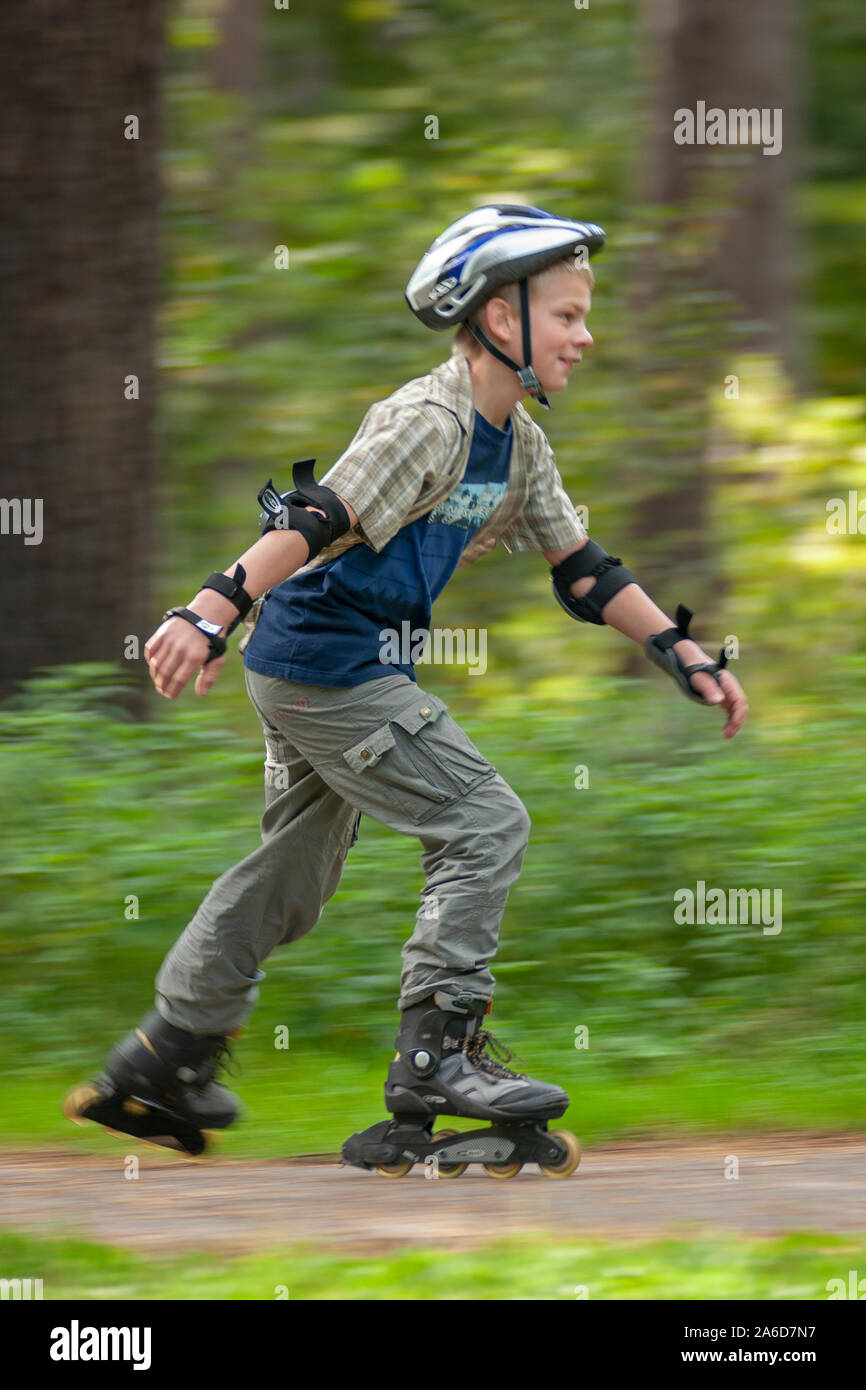 A young boy is skating in the countryside. Stock Photo
