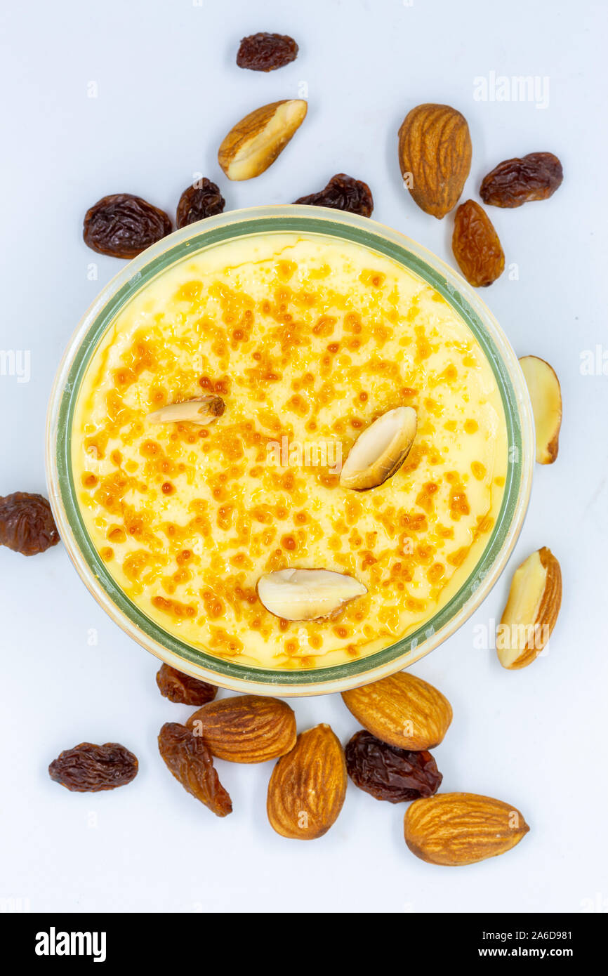 French creme brulee with almonds and raisins over head still life macro image Stock Photo