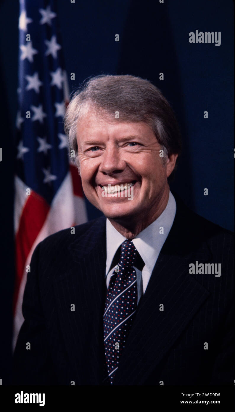 Portrait of President Jimmy Carter in dark suit with US flag in ...