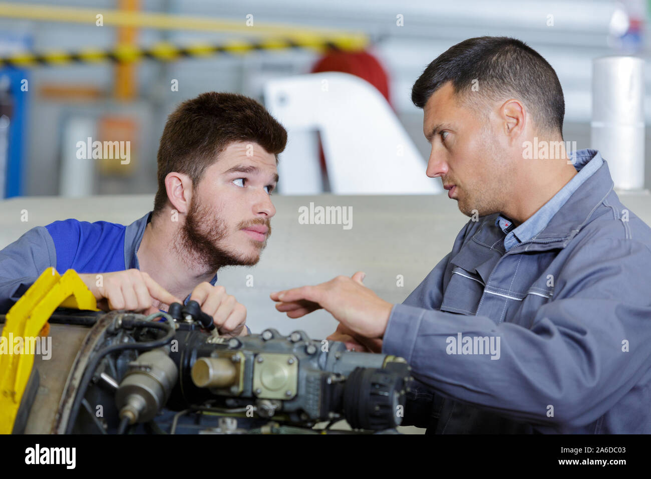 two mechanics working in auto service Stock Photo