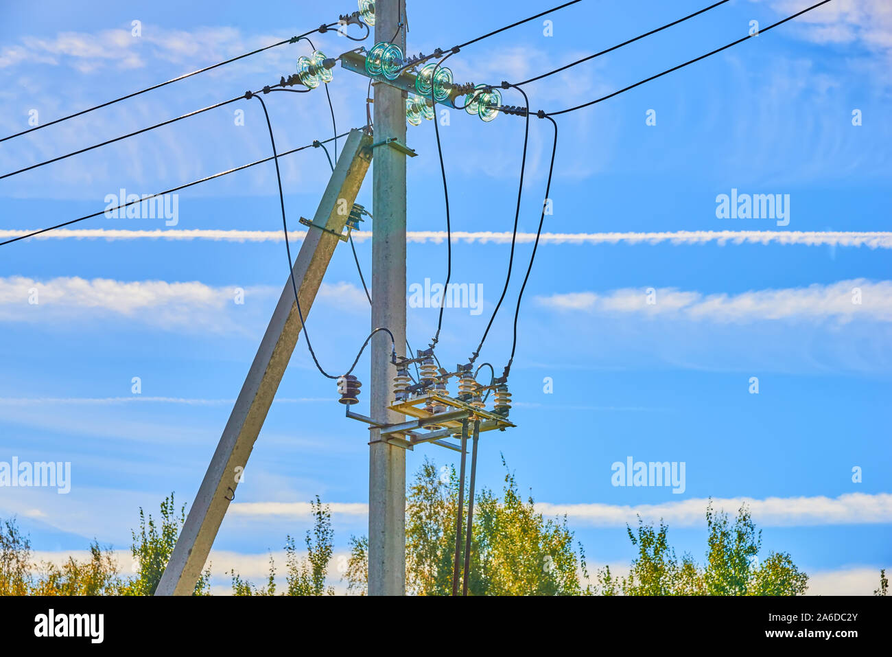 Electrical high voltage fuses on the grey concrete pillars on the blue clear sky on the background Stock Photo