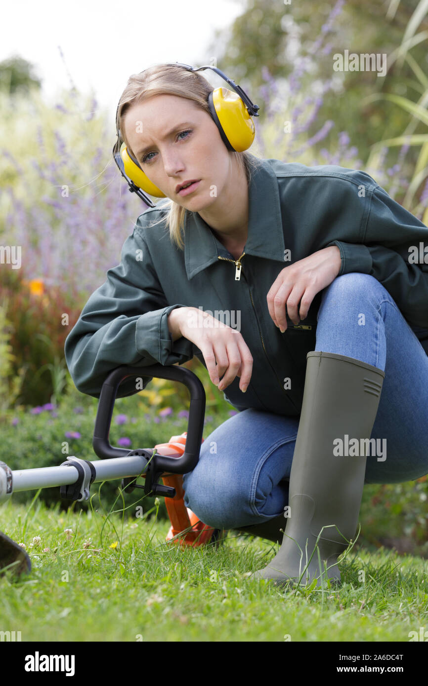 young woman wearing ear muffs in a garden Stock Photo