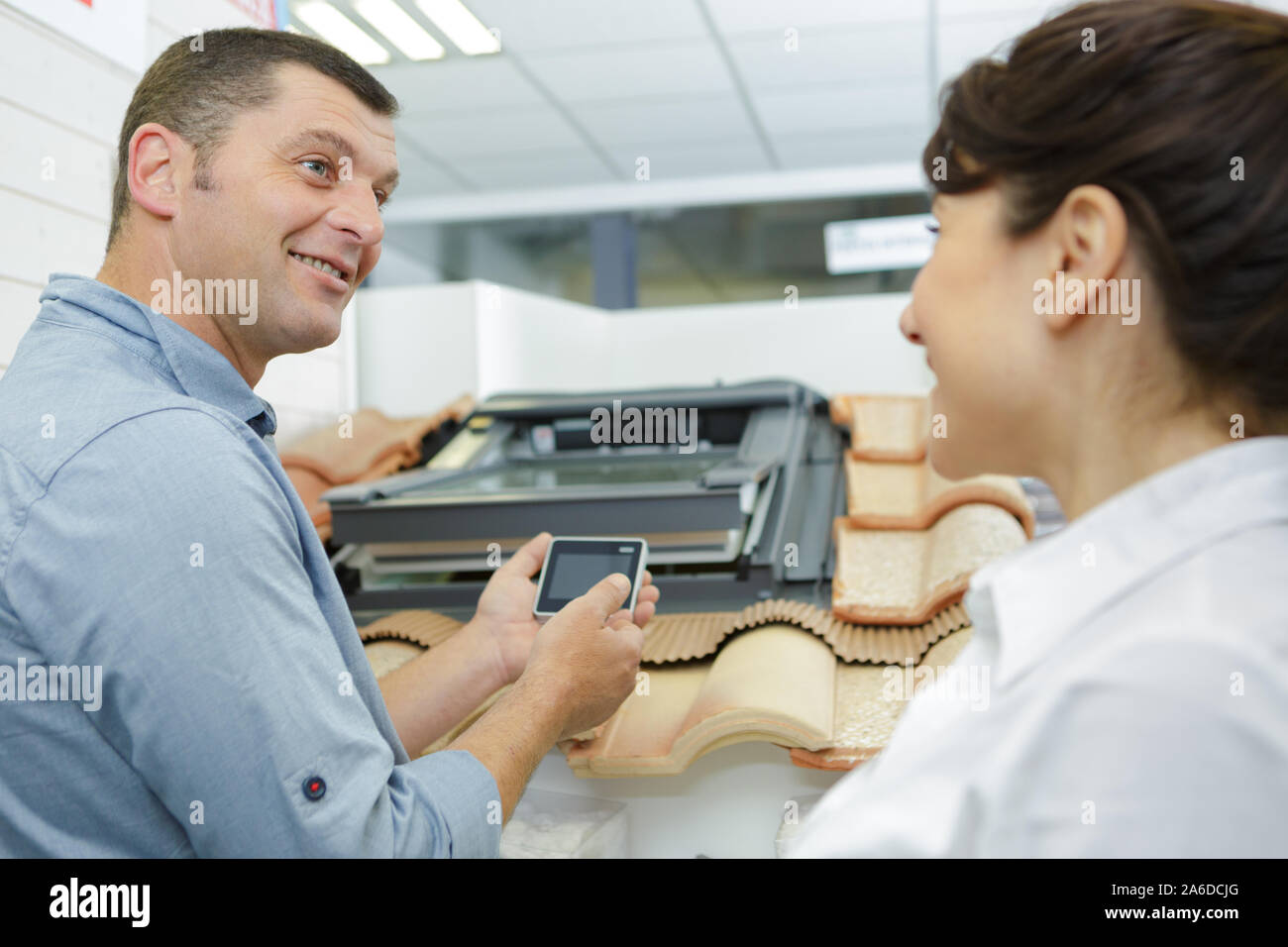 salesman showing rooflight controller to interested client Stock Photo