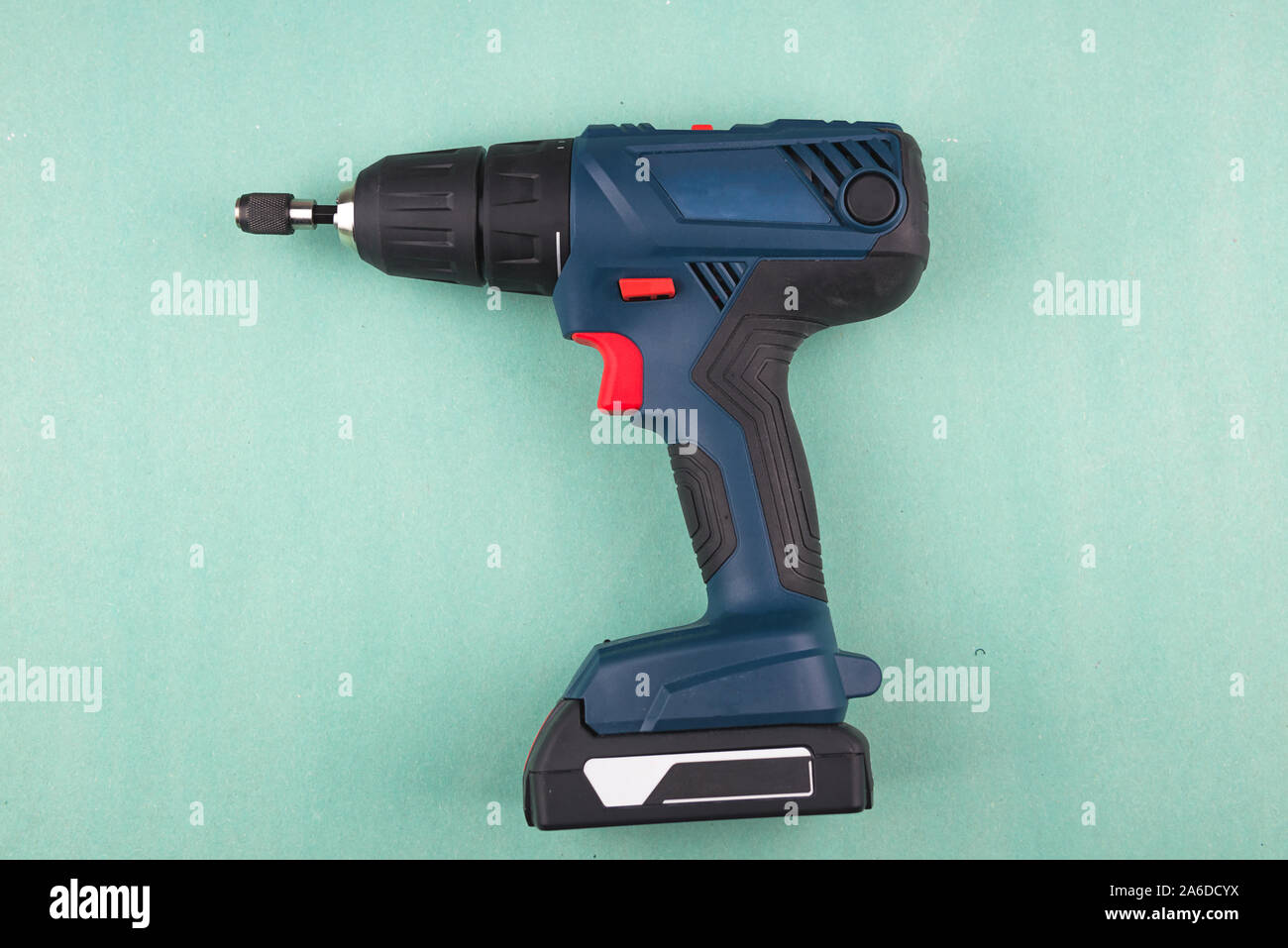 Blue screwdriver power tool on blue paper background. Suitable for any purprose use. Stock Photo